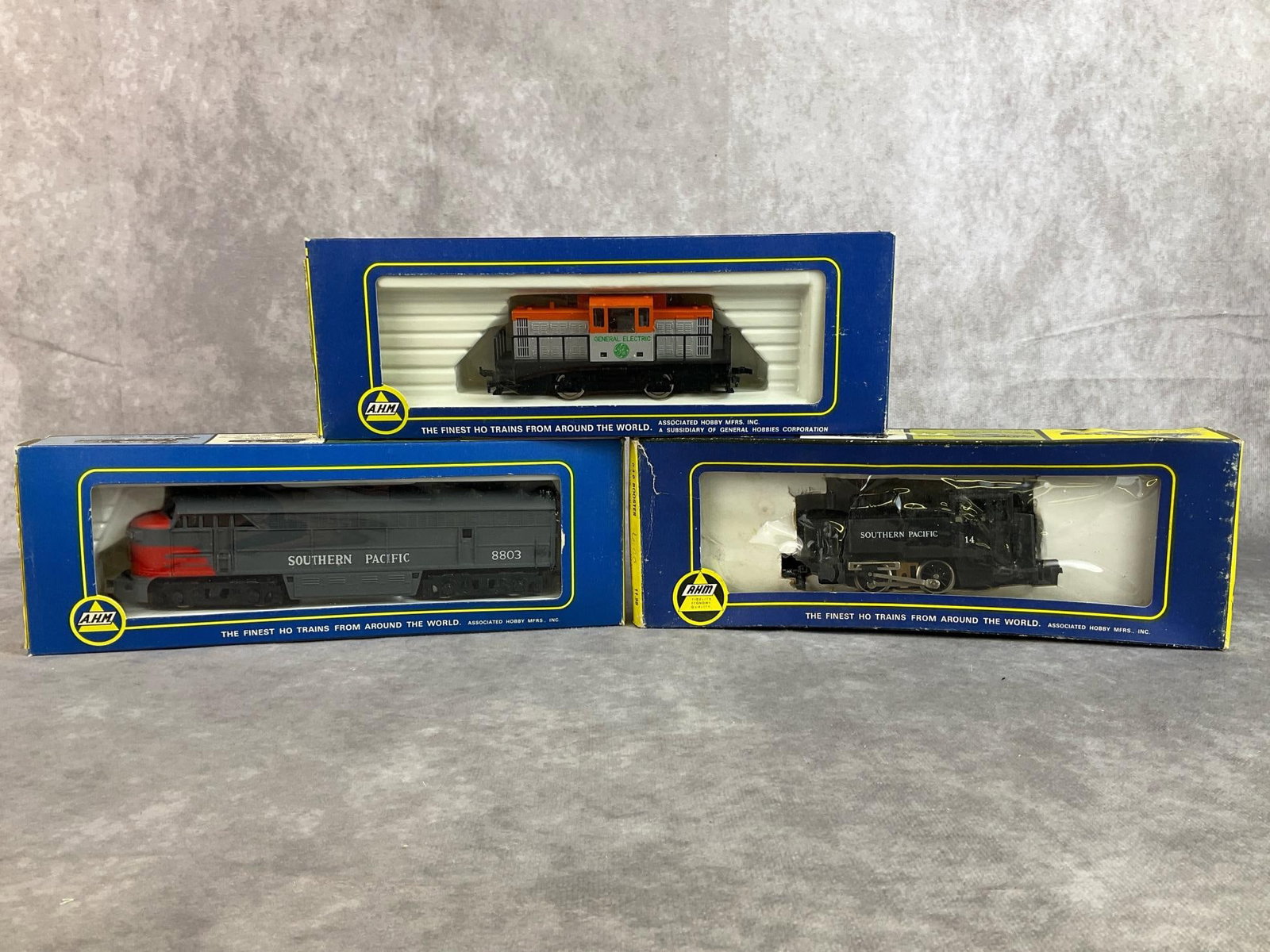 AHM Southern Pacific Train: Lot of three 1970s HO scale, Associated Hobby Manufacturers trains made in Italy, and Yugoslavia including FM Locomotive, 0 4 0 Booster, and Center Cab. All in good condition and comes with original b