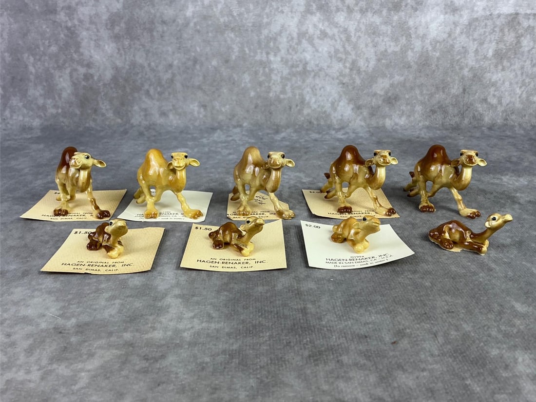 Hagen Renaker Camels: Lot of nine Hagen Renaker camels. Seven on original paper with two having broken front legs. Largest measures 2.5 inches wide x 1.75 inches tall.