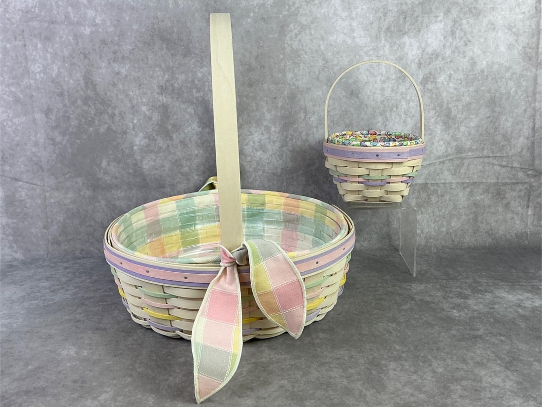 Longaberger Easter Baskets: 2000 Easter basket with original plastic liner, one 2001 Easter basket with fabric and plastic liner. Larger basket has COA, but both are stamped on the bottom. Larger basket measures 12 inches in dia