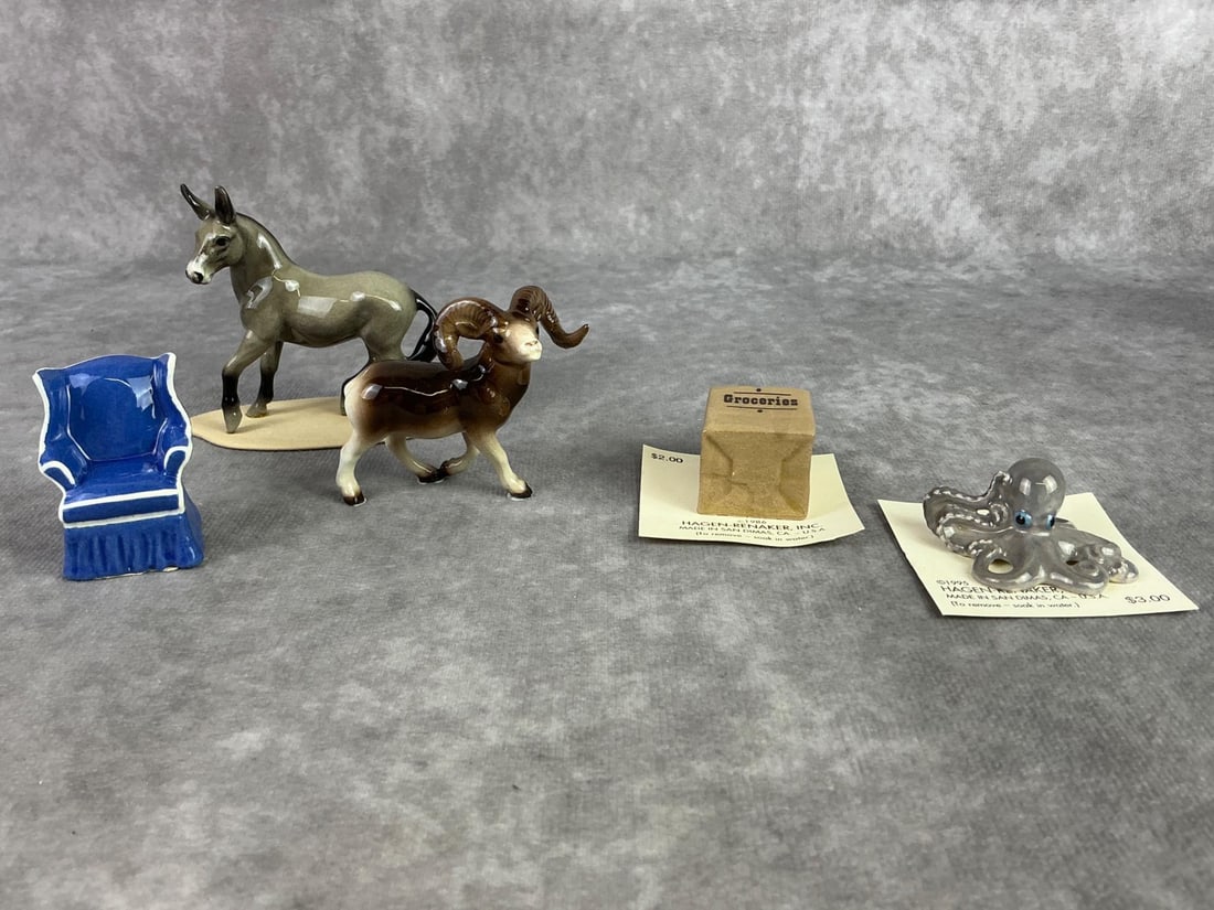 Hagen Renaker Mixed Lot: Lot of five Hagen Renaker figures including donkey, ram, octopus, chair, and grocery bag. All in good condition with two on original paper. Largest measures 3.25 inches wide x 2.75 inches tall.