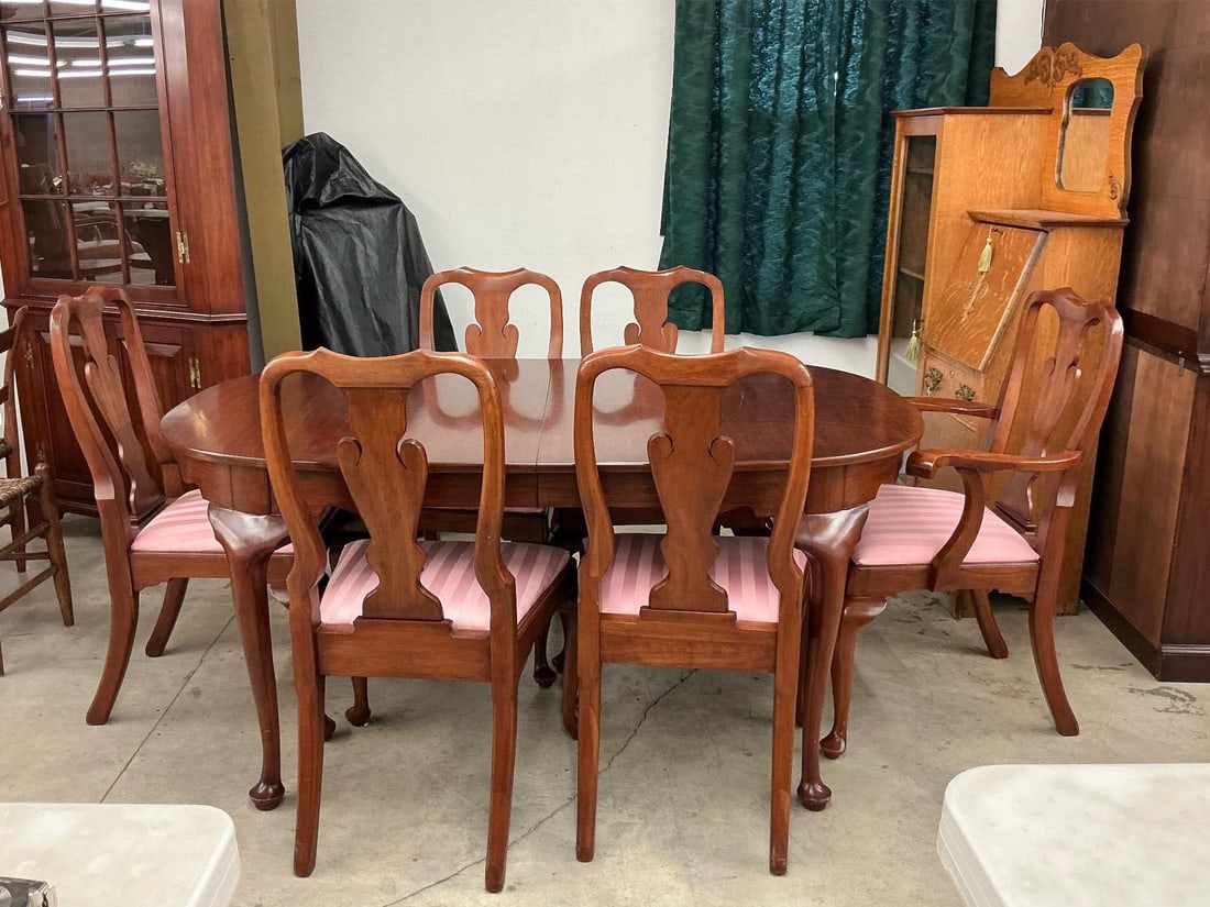 Henkal Harris Dining Room Table & Chairs: 1980s solid wild black cherry table and chairs dining room set made by Henkel Harris. Includes six chairs and three leaves. Tabletop has scratches and is scuffed. Measures 64 inches wide x 41 x 29 inc