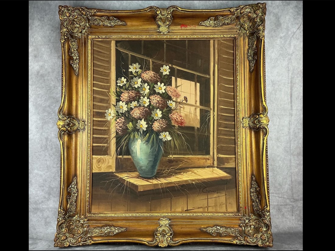 Floral Oil Painting: Painting of daisies and hydrangeas in a vase on a window seal. Signed L. Camille. Framed in a gold guild frame. Good condition, frame has red paint and minor chips. Painting measures 27 inches wide x