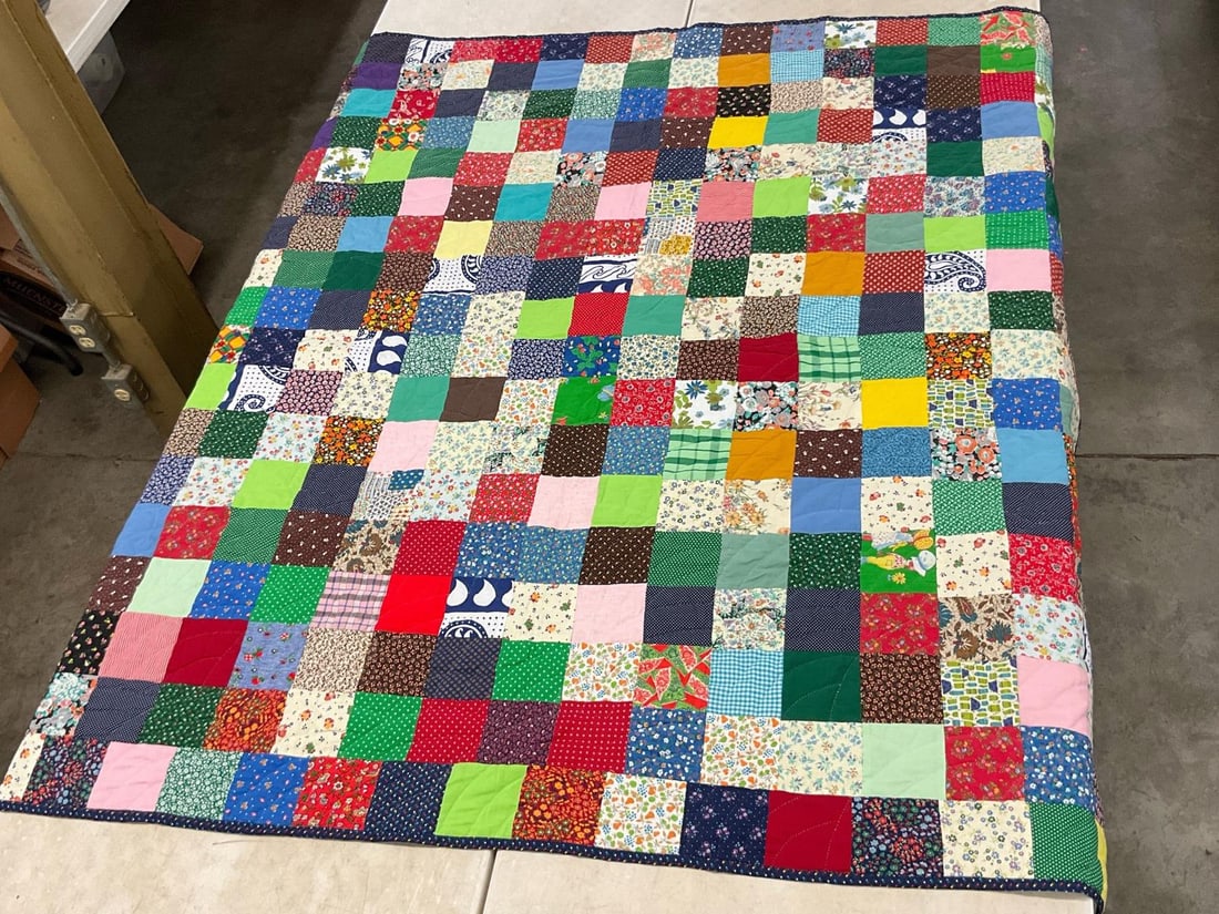 1970s Handmade Quilt: Patchwork quilt handmade in the 1970s with a blue floral backing. In good condition. Measures 80 inches long x 78 inches wide.