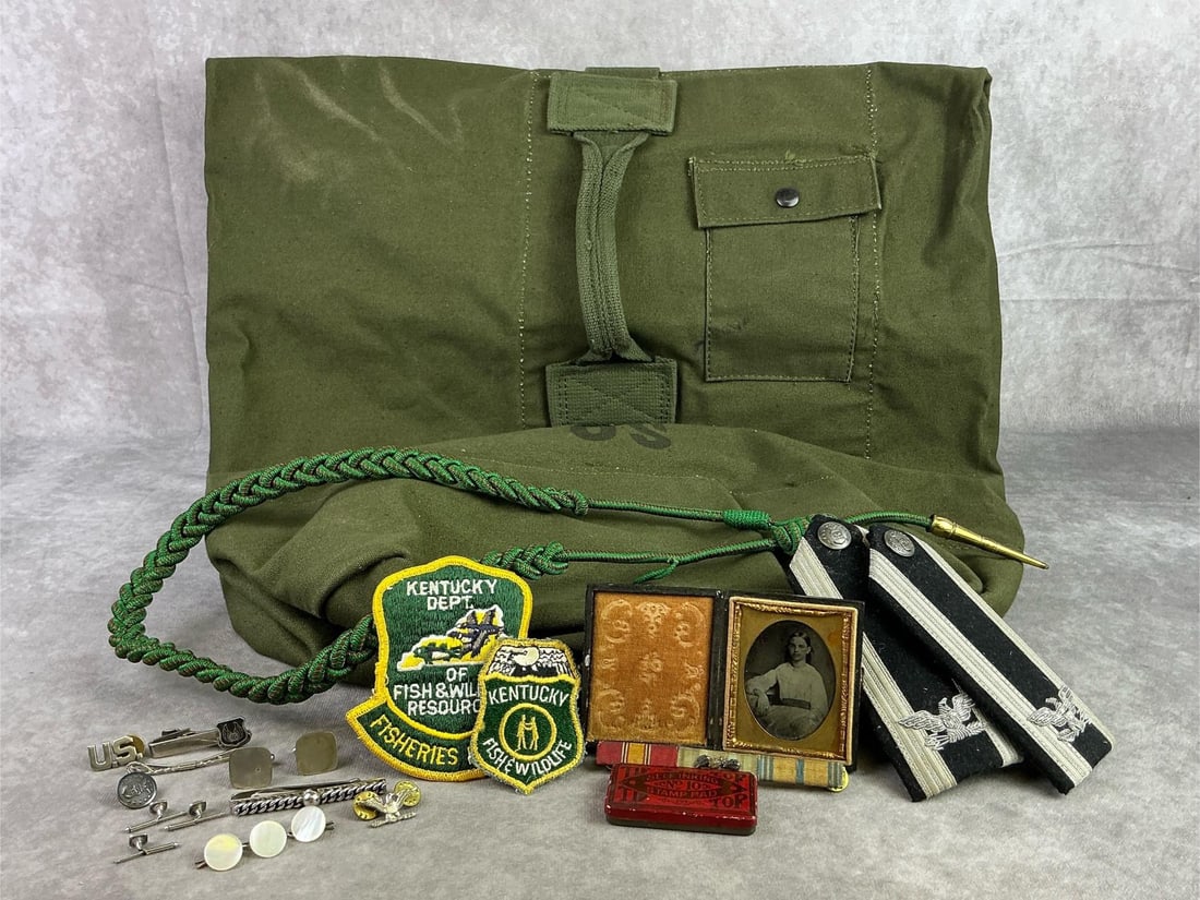 Militaria Finds: Lot of military finds including Vietnam Era duffle bag, Ambro type photo, Tip Top stamp pad, and more. All in fair to good condition with photo showing signs of age. Duffle measures 19 inches wide x 3
