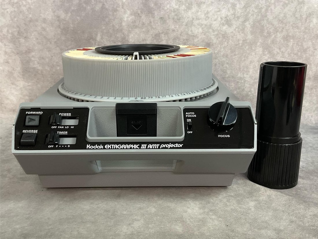 Kodak Ektagraphic III Projector: Vintage Kodak slide projector with 80 count slide carousel and a f:3.5 Kodak zoom lens. Original boxes, good condition, tested and working. Box measures 12 inches wide x 8.5 x 13.75 inches tall.