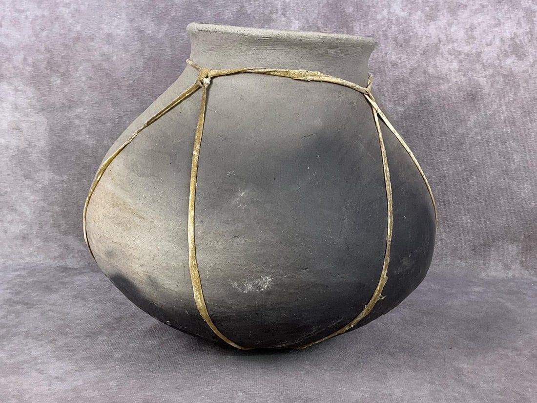Tarahumara Pot From Mexico: 1950s pottery pot made in the Sierra Madre mountains of Chihuahua Mexico. This pot was handmade by the pinch and coil method without the use of a wheel with sinew lace wrapping. In good condition. Mea