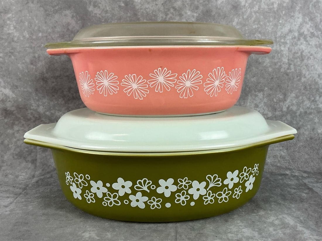 Daisy Pyrex Casserole Dishes: One large green Crazy Daisy casserole dish and one Pink Daisy Casserole dish. Both with original lids. Both have yellowing and flea bites, but are in good condition. Crazy Daisy dish measures 13 feet