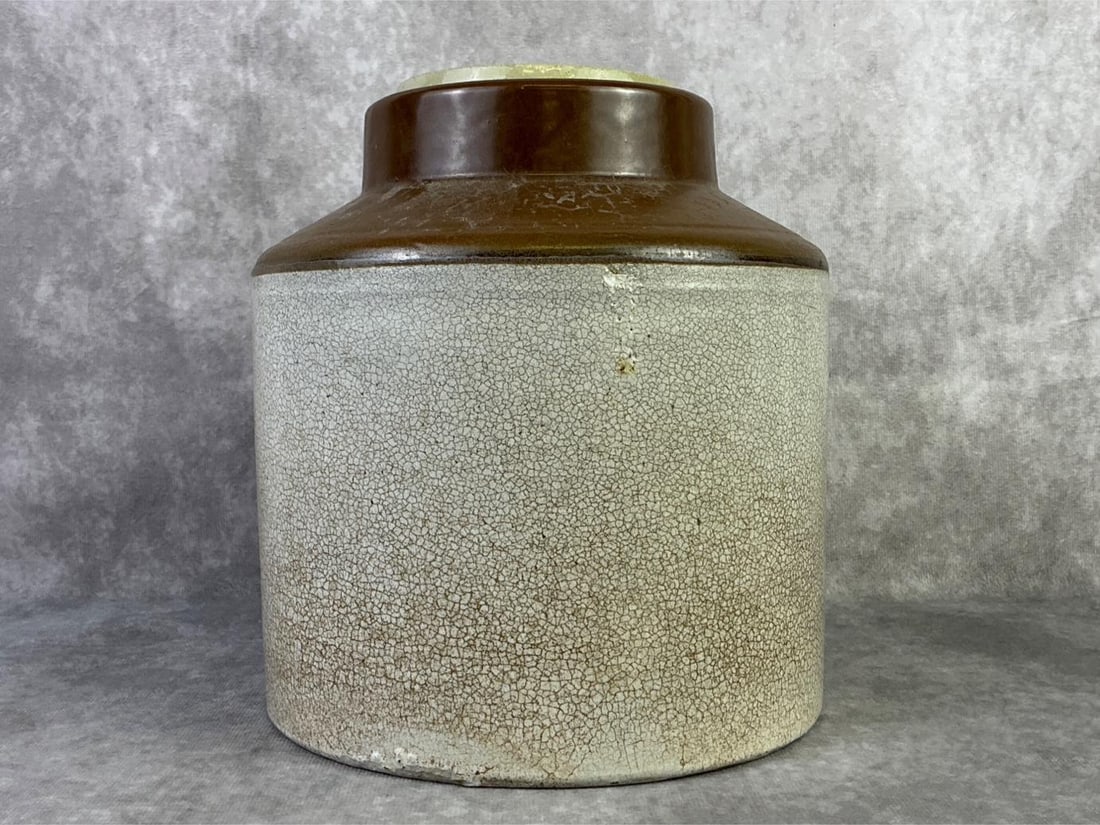 Buckeye Stoneware Crock: The Buckeye Pottery Company stoneware crock with lid. In good condition with minor chips at rim and base. Crock measures 7.5 inches wide x 9 inches tall.