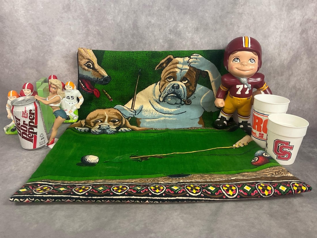 Sportsman Lot: Vintage dogs playing pool tapestry, ceramic football player, plastic bookends, and more. Scuffs to ceramic player and bookends. Tapestry measures 57 inches wide x 39 inches long when open.