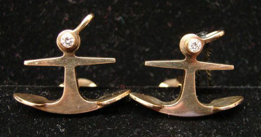 Ole Lynggaard Jewelry: Ole Lynggaard anchor cufflinks in 18k yellow gold with .15cttw accent diamonds. Marked "OLEL 750 18k." Model# 550-4. 18.2 grams total weight. Comes with original Lynggaard tag. Original retail $2,100.