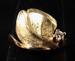 Ole Lynggaard Jewelry: Ole Lynggaard leaf ring in 18k yellow gold with single accent diamond (.5 cttw). Marked "OLEL 750 18k." 5.1 grams total weight. Model# 728.4. Comes with original Lynggaard tag. Original retail $575.