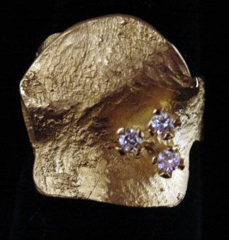 Ole Lynggaard Jewelry: Ole Lynggaard leaf ring in 18k yellow gold with three accent diamonds (.12 cttw). Model# 662-4. Marked "OLEL 750 18k." 10.0 grams total weight. Comes with original Lynggaard tag. Original retail $1,20