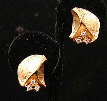 Ole Lynggaard Jewelry: Ole Lynggaard leaf earring, clip-on style in 18k yellow gold with three accent diamonds on each one (.25 cttw). Marked "OLEL 750 18k." 12.2 grams total weight. Comes with original Lynggaard tag.