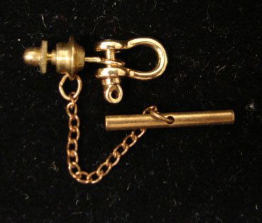 Ole Lynggaard Jewelry: Ole Lynggaard working shackle tie tack in 18k yellow gold. Marked "OLEL 750 18k." Model# 822-4. Catch and chain are not gold. The shackle and post are 2.8 grams total weight. Comes with original Lyngg