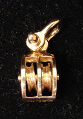Ole Lynggaard Jewelry: Ole Lynggaard working shackle and block pendant in 18k yellow gold. Marked "OLEL 750 18k." Model# 540-4. 11 grams total weight. Comes with original Lynggaard tag. Original retail $900.