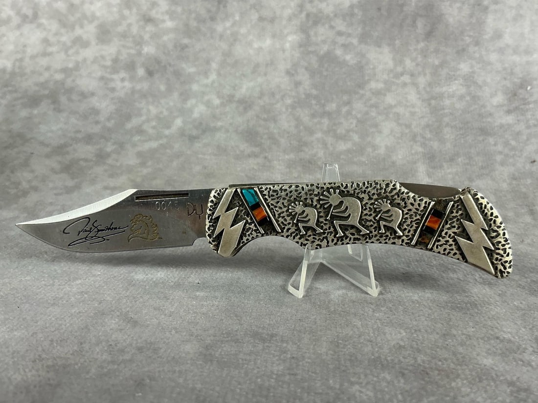 David Yellowhorse Kokopelli Silver Series Knife: Silver Series Fourth Edition Kokopelli Knife. Number 0045 of 2500. In good condition, never sharpened or carried, but snap is loose. David Yellowhorse signature etched into blade with golden horse emb