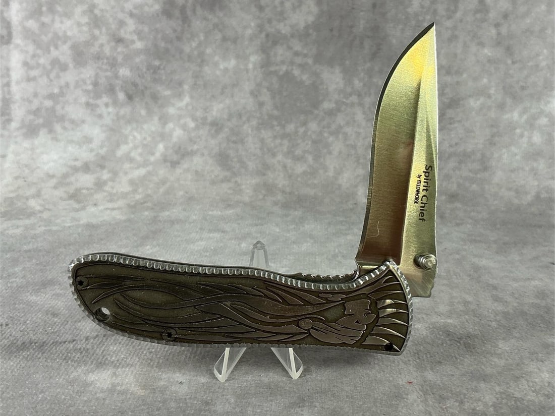 David Yellowhorse Spirit Chief Custom Knife: Spring assist knife, with his designs engraved into stainless steel, with hand textured surrounds. Made in 2024. Signature etched into blade. Never sharpened or carried. Comes with COA and original bo