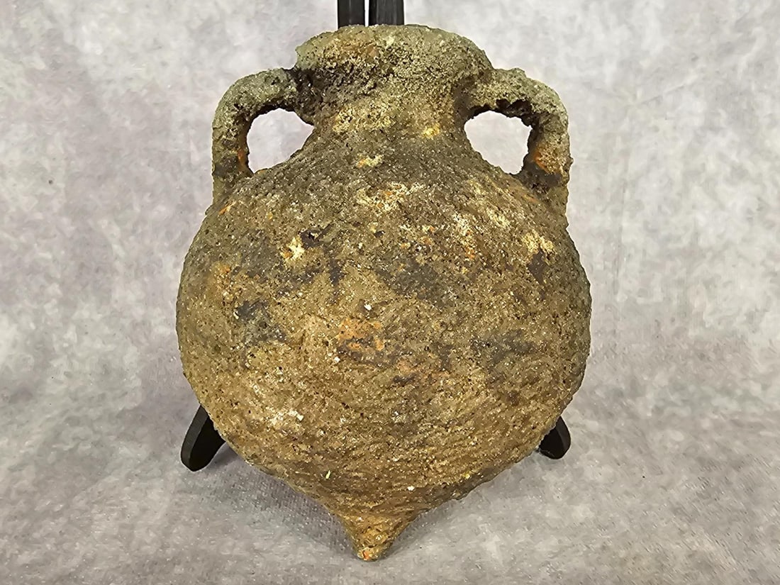 Ancient Amphora: Possibly Greek or Roman from the first century A.D. It is marine-encrusted terrecotta transport vessel. Does have a chip on one handle and bottom tip. Measures 5 inches wide x 6.5 inches tall.