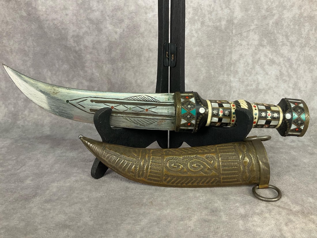 Syrian Jambiya Dagger: Late 1800s, early 1900s Syrian Jambiya Dagger with brass sheath made in the village of Magdal Shams. Handle is made of carved horn, inlaid bone and mother of pearl.blade is hand etched and inlaid with