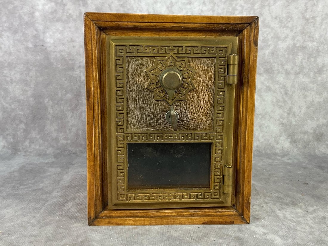 Post Office Box Bank: Circa 1960s post office box converted to bank with original brass door. Box is oak and code to door is listed on bottom of bank. Good condition, measures 4.75 inches long x 5.25 deep x 5.75 inches tal