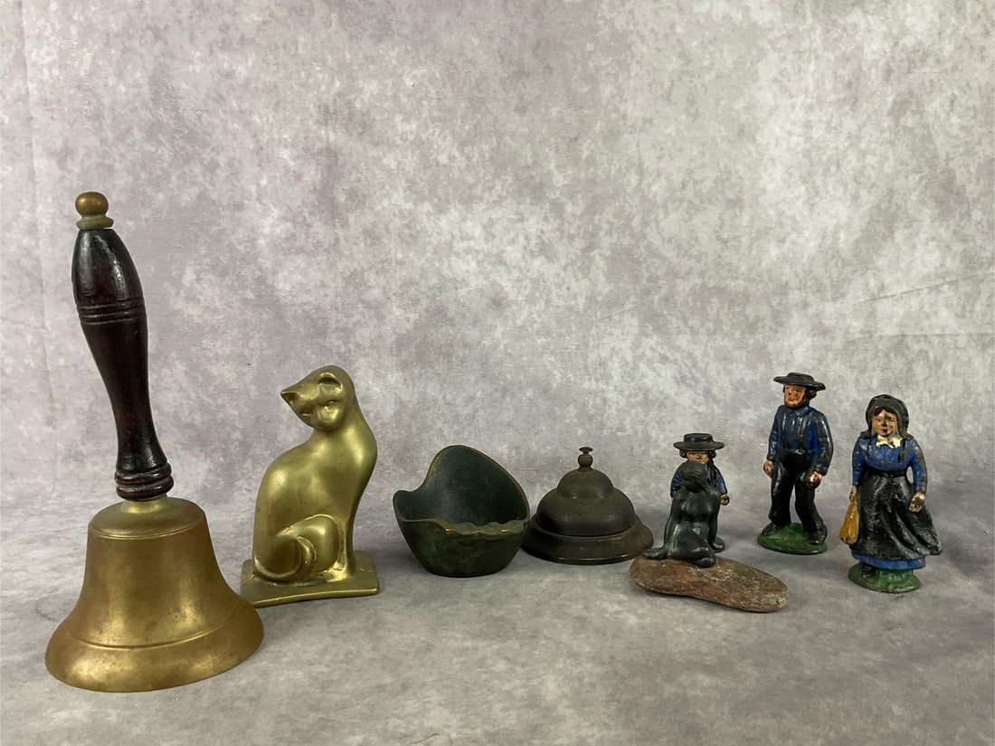 Mid Century Home Decor: Eight pieces of Mid Century brass and cast iron home decor. Two brass bells, both which ring, Three Amish cast iron figurines, a brass ashtray by CARL AUBOCK. Also, a brass cat and Mermaid sitting on
