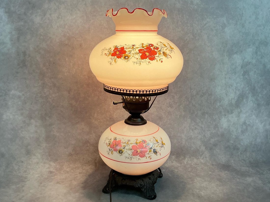 Electric Mid Century Hurricane Lamp: Mid century hand painted floral lamp. Three way electric upper and lower globes Victorian style table lamp. In good condition. Measures 8 inches in diameter x 19.5 inches tall.