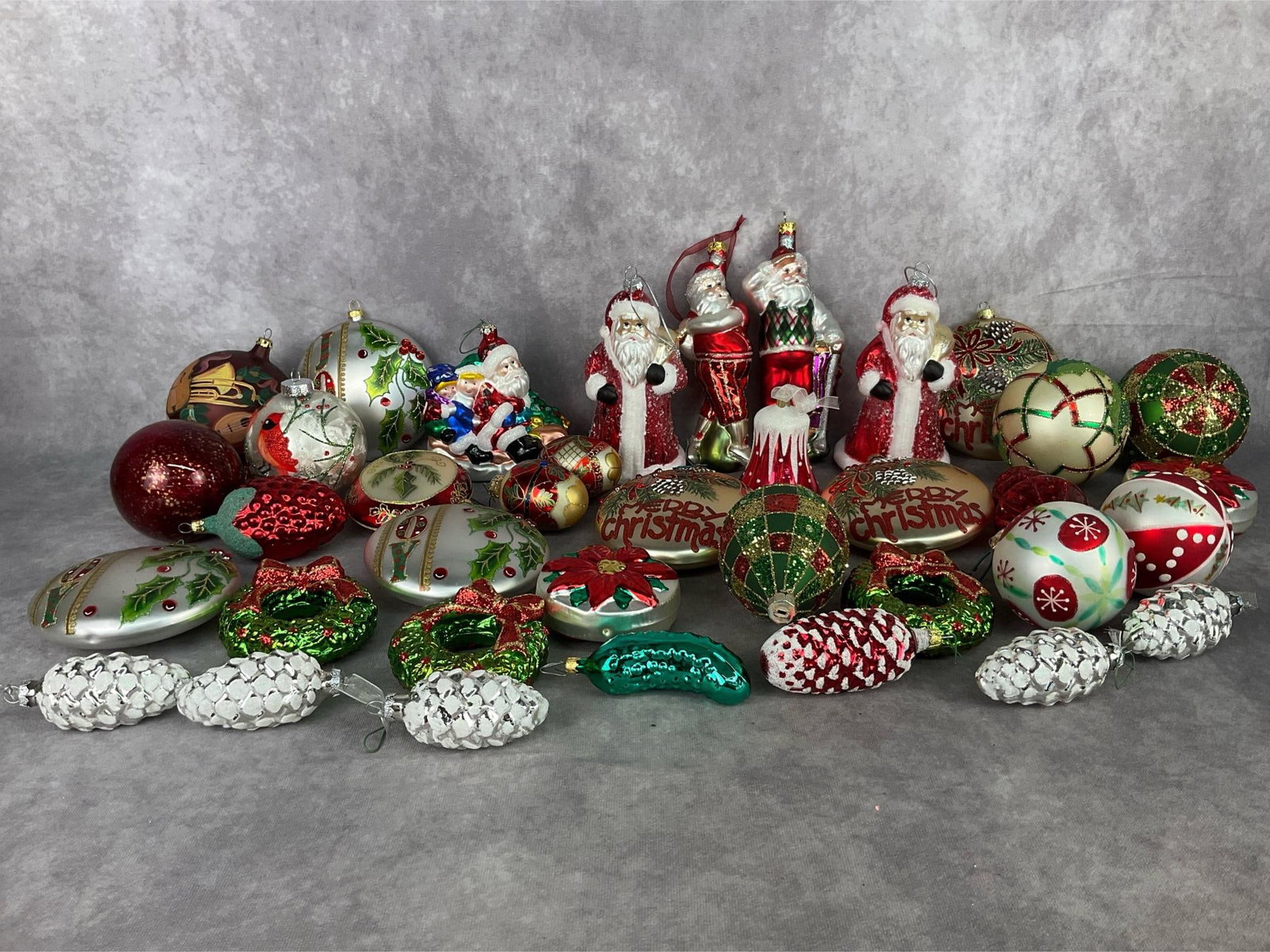 Christmas Ornaments: Large Lot of modern glass Christmas ornaments. Included are two golfing Santas, pinecones, wreaths, plaid, and more. Minor paint loss on some, overall god condition. Golfing Santa measures 8 inches ta