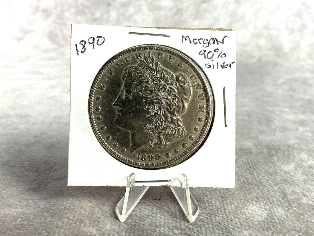 1890 Morgan Silver Dollar: 1890 Morgan silver dollar, almost uncirculated condition. Weighs 0.92 ozt with coin sleeve.