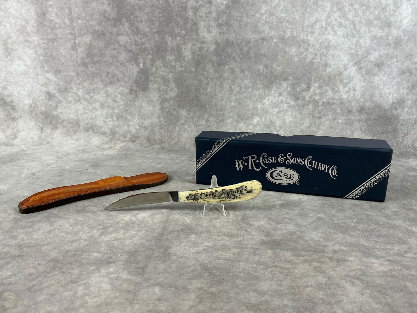 Case XX Office Knife: No. 617-3 Case office knife with leather sheath and original box. Never carried or sharpened. Good condition. Knife measures 6 inches long. Box measures 8.25 inches wide x 2 x 2.5 inches tall.