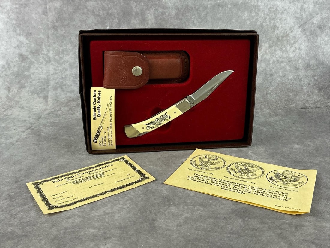 Schrade Bald Eagle Commeratibe Scrimshaw Knife Set: Includes Schrade single blade lockback knife , sheath , paperwork, and box. Knife is in good condition , but bolsters have a residue from storage. Knife measures 4 inches wide. Box measures 8.5 inches