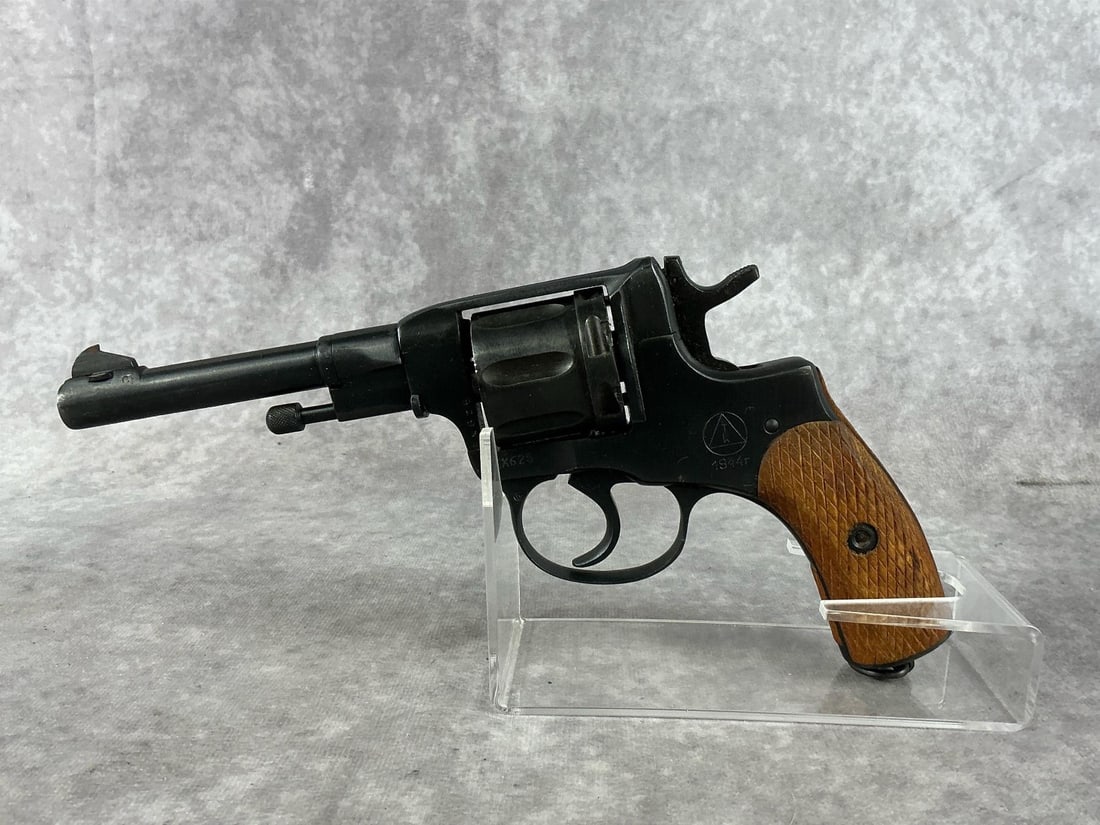 Russian Nagant 7.62 Revolver: Serial No. EX625. WWII revolver made in 1944. Patina present to cylinder release, bore is in good condition. Comes with original holster. Barrel measures 4 inches long, revolver measures 10 inches tot