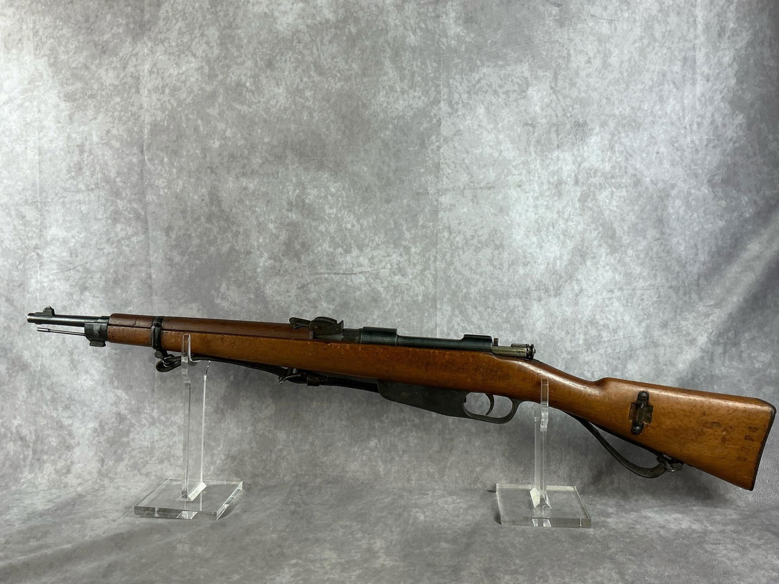 Italian 6.5 Carcano Rifle: Serial No. BB577. 1891/28 carbine. Patina is present to the receiver, and sight. Fair to good condition. Barrel and bore are in good condition. Missing clip, has original strap. Barrel measures 18 inc