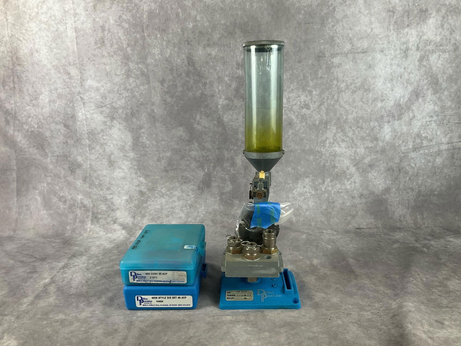 Dillon Reloading Toolhead with Stand: Dillon Reloading Toolhead and Stand set with 45 ACP Dies, Conversion Kit included. Used in good condition. Measures 5 inches wide X 4.5 X 16 inches tall.