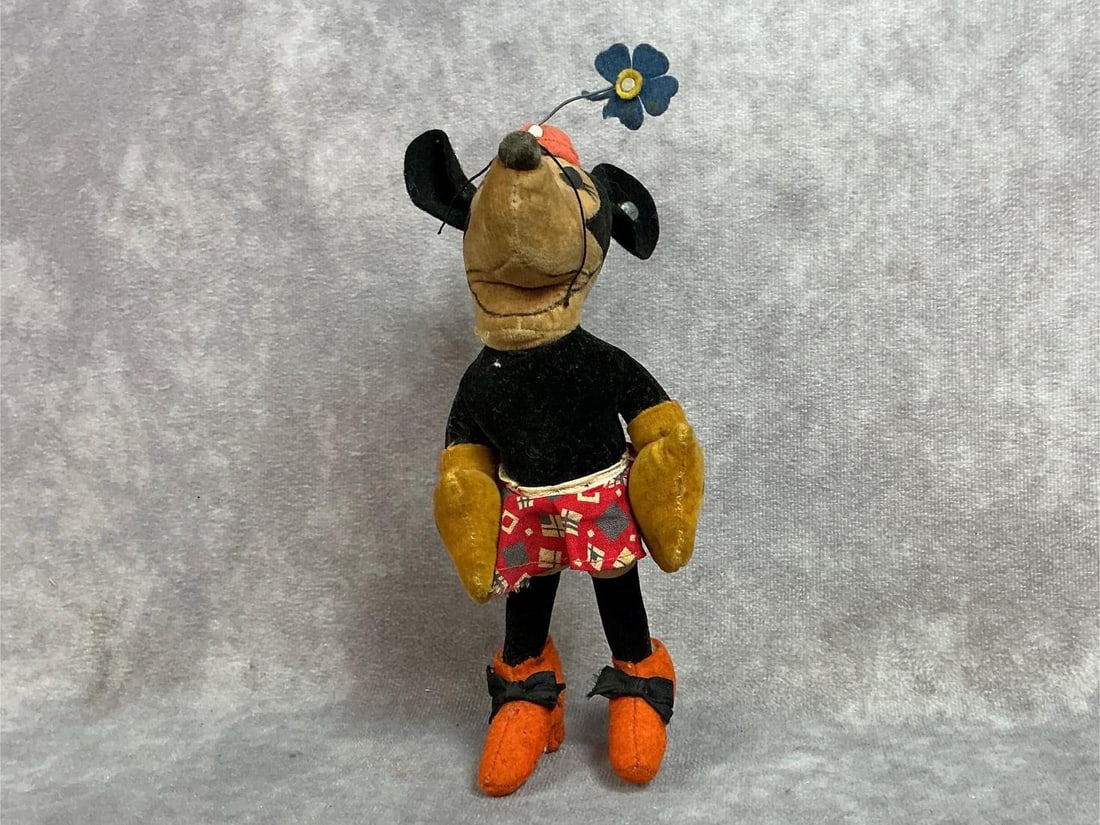1930s Steiff felt Minnie Mouse made in Germany with hand drawn facial features. Metal tag marked: 1930s Steiff felt Minnie Mouse made in Germany with hand drawn facial features. Metal tag marked Steiff in ear. Several small loses to felt. Measurement 3 inches wide x 8 inches tall.
