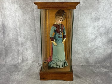 Late 1800s-early 1900s porcelain doll with mink hat and muff. Incased in a glass and oak case. The