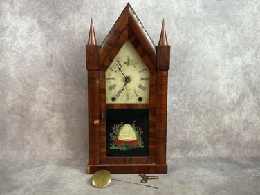 1850s Brewster and Ingrahams steeple clock with a beehive on front glass being a later replacement.
