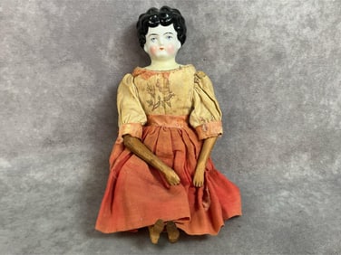 1890s porcelain head doll with carved wood body. Back of porcelain head is marked with a 2, wood