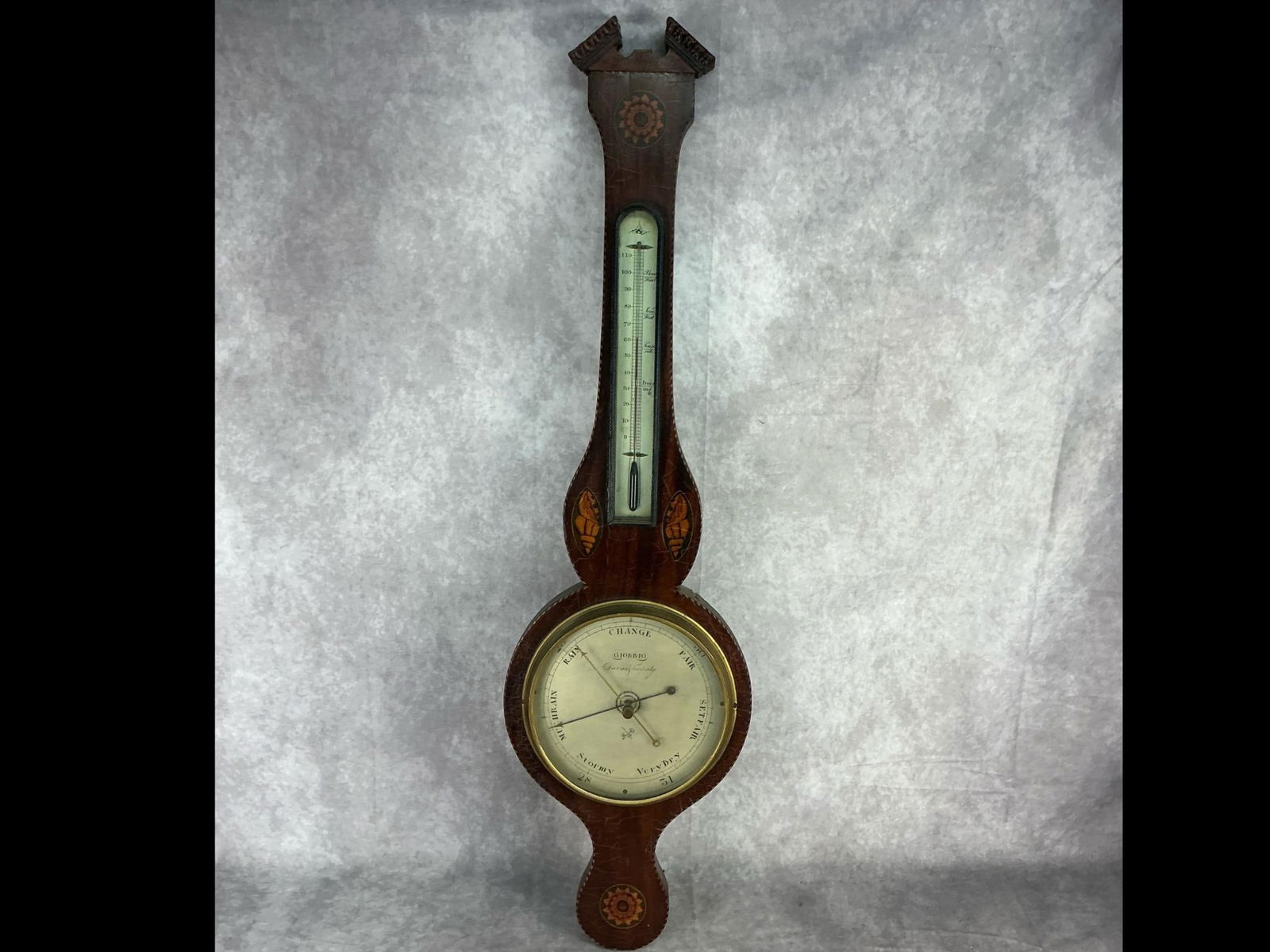 19th century mahogany weather station with barometer and thermometer. Shell and floral inlay. Dial: 19th century mahogany weather station with barometer and thermometer. Shell and floral inlay. Dial marked with maker's name - "Giobbio". Circa 1820. Barometer not working. Finial missing. Thermometer