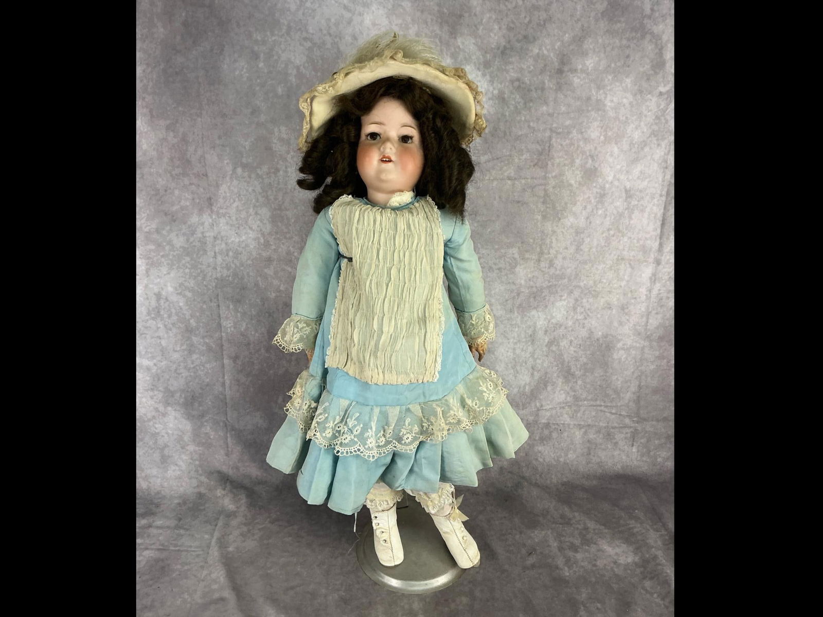 Early 20th century Armand Marseille child doll with bisque head, composition body and original: Early 20th century Armand Marseille child doll with bisque head, composition body and original period clothing.Ring on finger. Stamped "Armand Marseille Germany A 11 M" to back of neck. Shoe sole loos