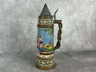 Early 20th century German stein with depiction of German couple and village. Marked two liter and