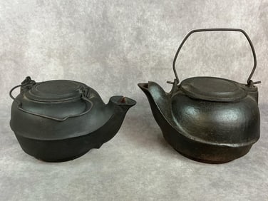 Two late1800s to early 1900s kettles. Cast iron humidifier style kettles with swivel lids. Rust