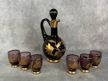 Mid century decanter with 6 glasses. Bohemian amethyst glass with gold trim and floral design. Six