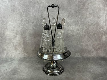 Late 1800s cruet set. Silver plated condiment stand holds five etched glass dispensers. Cruet or