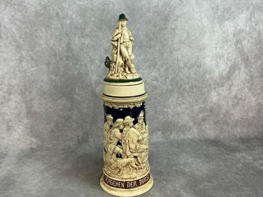 Early 1900s beer stein. German stein with lettering and a gathering depicted in raised relief