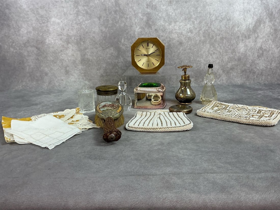 Thirteen early to mid 1900s items. Includes Victorian sterling hairbrush with deer scene and antler: Thirteen early to mid 1900s items. Includes Victorian sterling hairbrush with deer scene and antler handle, Seiko gold tone clock and glass perfume bottles. Also two handkerchiefs, jeweled box, and mo