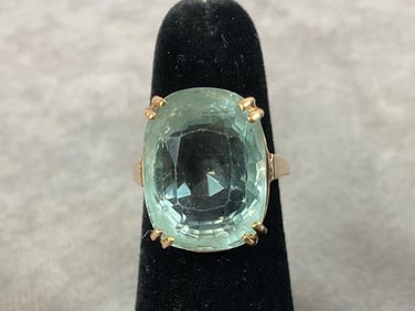 Size 5.5, 14.50 carat aquamarine stone set in 14kt gold. The stone is oval cushion cut and the color