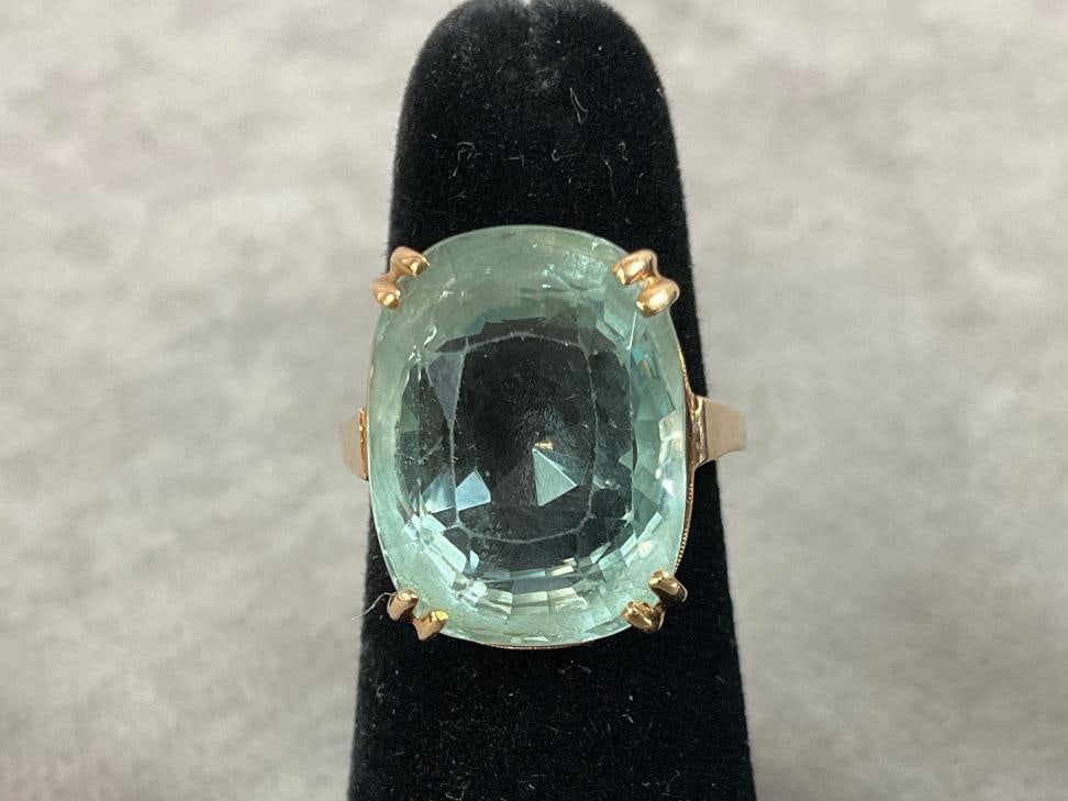 Size 5.5, 14.50 carat aquamarine stone set in 14kt gold. The stone is oval cushion cut and the color: Size 5.5, 14.50 carat aquamarine stone set in 14kt gold. The stone is oval cushion cut and the color is moderately greenish blue, it does have some nicks and abrasions. Total gem weight is 9.3 grams. 