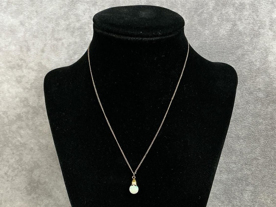 Vintage 12kt gold chain with a floating opal pendant. Chain is marked 12k on clasp. Total weight is: Vintage 12kt gold chain with a floating opal pendant. Chain is marked 12k on clasp. Total weight is 0.7 dwt.