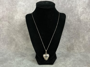 Sterling silver heart shaped locket that folds out into a four leaf clover shape. Locket is marked