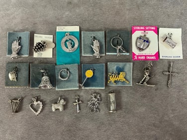 Twenty sterling silver charms and pendants. The two praying hands charms are not marked. Total